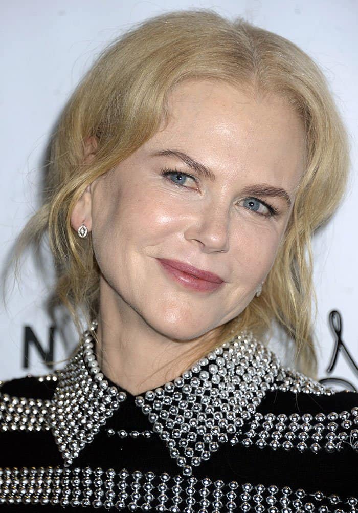 Nicole Kidman radiates elegance with soft pink makeup, a polished wavy updo, and minimal yet sparkling jewelry