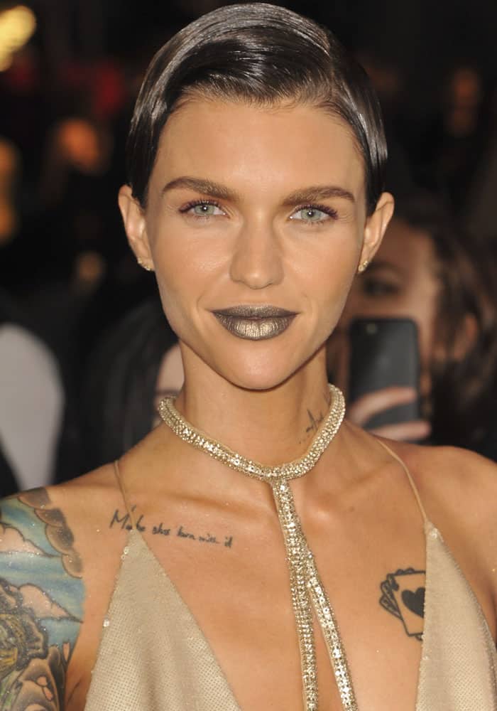 Ruby Rose made a bold statement with metallic gold lipstick, a slicked-back hairstyle, and a sparkling chain necklace at the xXx: Return of Xander Cage premiere