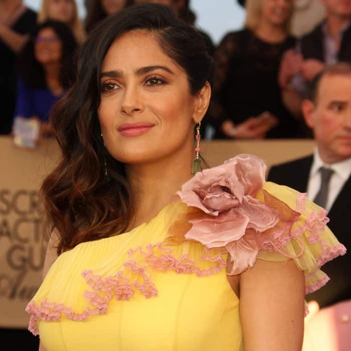 Salma Hayek completed her look with soft, romantic waves, subtle makeup highlighting her natural beauty, and colorful dangling Irene Neuwirth earrings