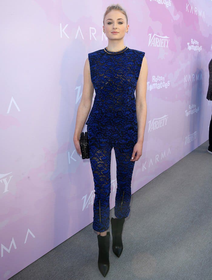 Sophie Turner effortlessly demonstrates how to wear a bold lace jumpsuit by pairing it with sleek color-block booties and a minimalist clutch at Variety’s Celebratory Brunch at Cecconi’s restaurant in West Hollywood on January 28, 2017