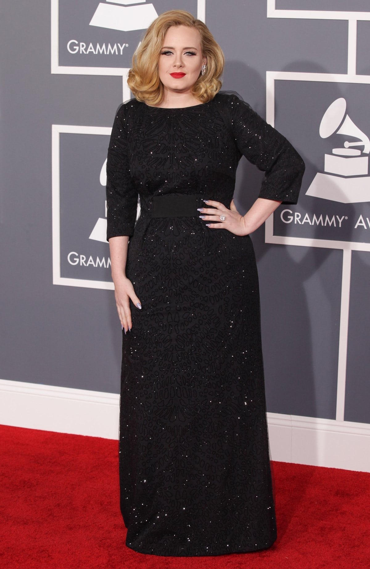 Singer Adele in a sparkling Giorgio Armani gown and De Beers earrings at the 54th Annual GRAMMY Awards
