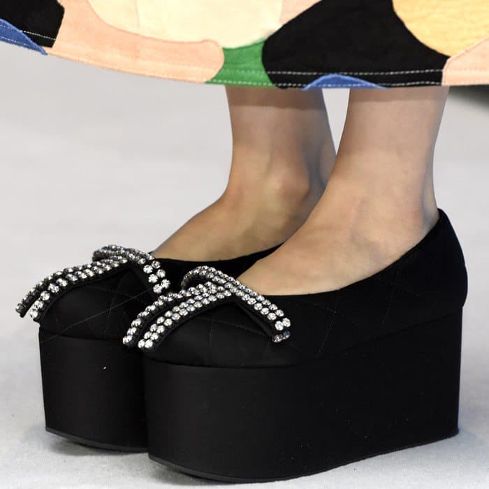 Amira Casar's black Marni platform wedges feature a quilted satin finish, bold embellishments with sparkling crystals, and a striking chunky sole