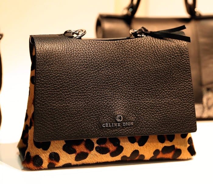 A bold Céline Dion handbag featuring a textured black leather flap and a striking leopard print bottom