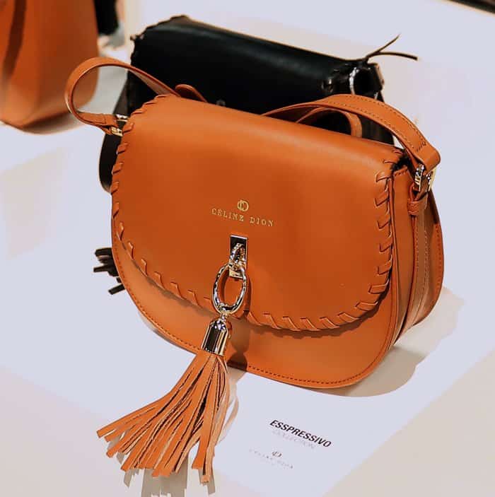 A sleek leather handbag from Céline Dion's collection featuring braided details and a chic tassel accent