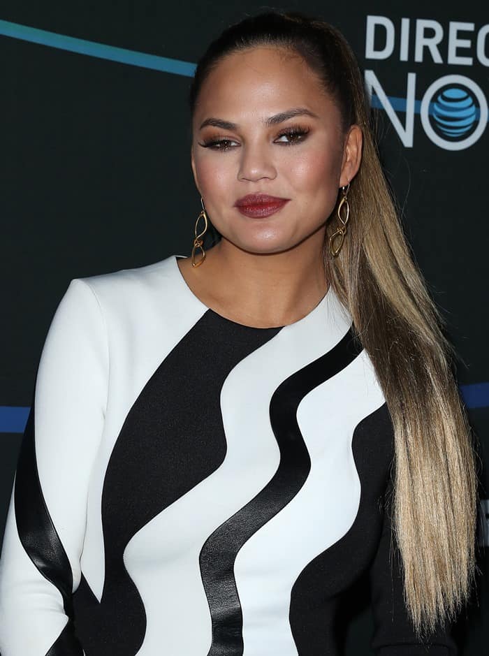 Chrissy Teigen styled her sleek ponytail with bold LACE by Jenny Wu earrings, perfectly complementing her striking black-and-white dress