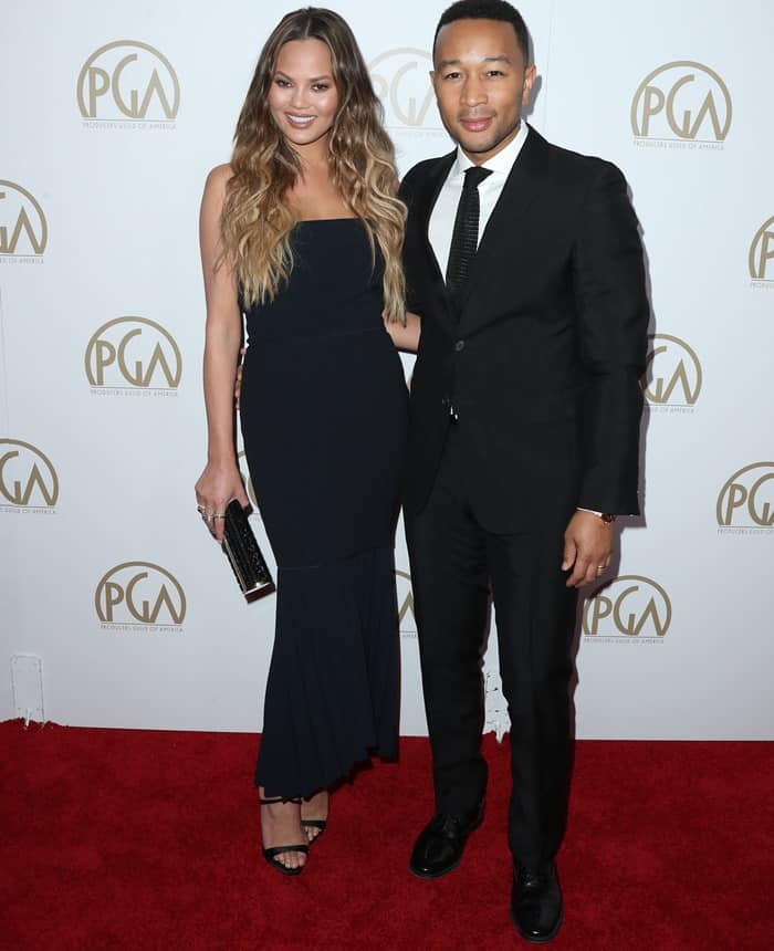 Chrissy Teigen and John Legend exuded elegance on the red carpet, with Chrissy in a midnight blue strapless dress and John in a classic black suit and tie