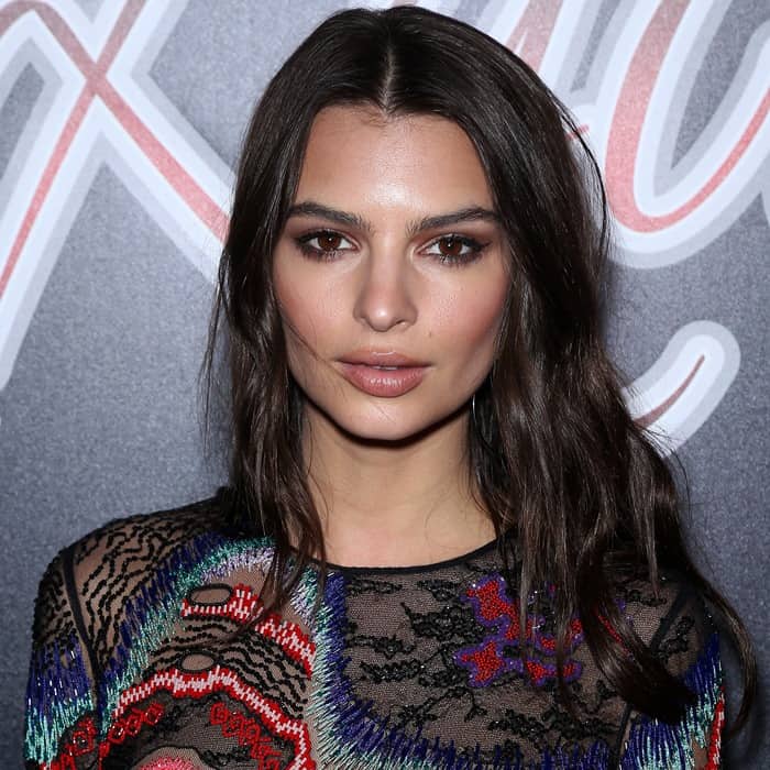 Emily Ratajkowski radiates elegance with her softly tousled hairstyle, subtle smokey eye makeup, and striking brown eyes