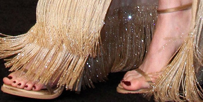 Emma Stone showcased her pedicure in a custom pair of Givenchy satin sandals, perfectly complementing her fringe-detailed gown