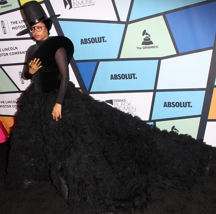 Erykah Badu stuns in a dramatic black Ashi Studio gown featuring a voluminous textured skirt, sleek bodice, and bold accessories