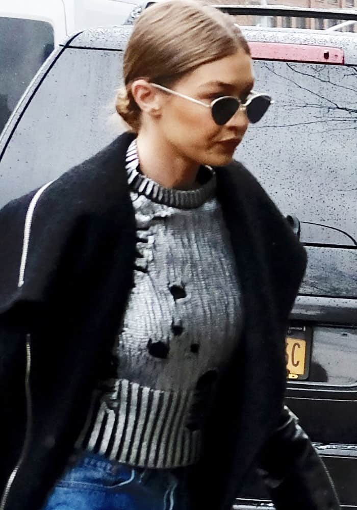On January 31, 2017, Gigi Hadid was spotted entering a New York hotel wearing a Zoë Jordan cashmere foil "Euler" sweater, elegantly layered beneath a black Rudsak "Cece" coat