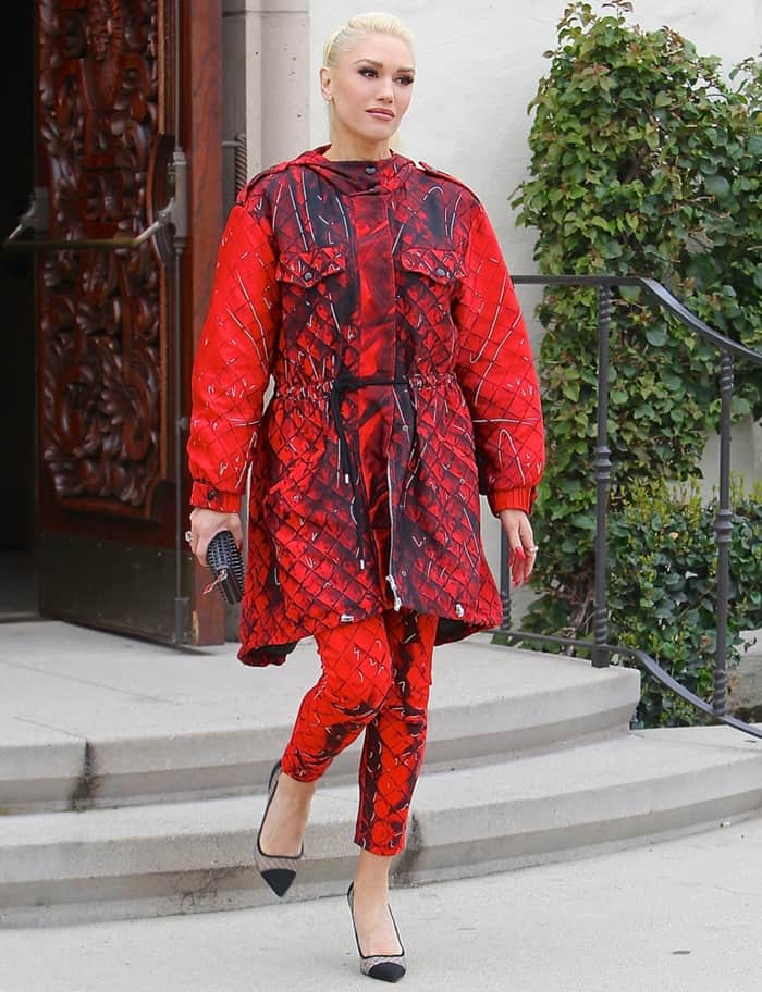 Gwen Stefani rocks a red and black coat with matching pants from Moschino