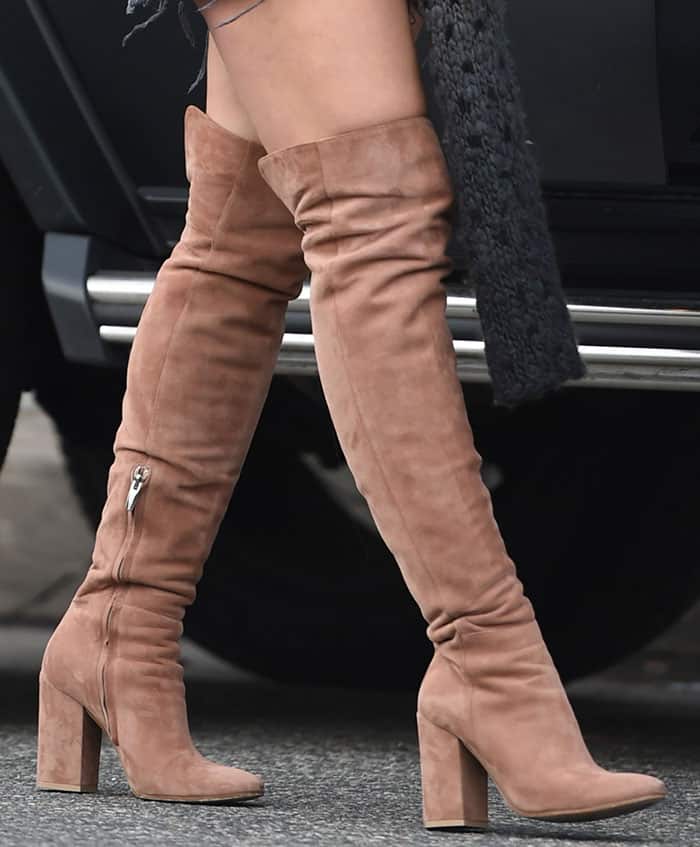 Hilary Duff's Gianvito Rossi boots feature a luxurious tan suede finish, slouchy knee-high design, side zippers for easy wear, and chunky block heels for a comfortable yet stylish look