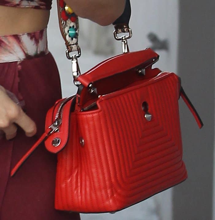 The Fendi DotCom bag seen on Kate Hudson features luxe chevron quilting, a structured silhouette, and silver-tone hardware, including a signature cone-shaped stud and dual top zippers—balancing function with standout fashion appeal