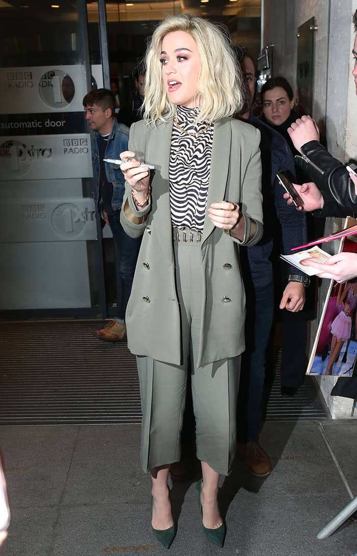 Katy Perry wearing an Elisabetta Franchi blazer and culottes, a Vanessa Seward turtleneck top, and green suede pumps