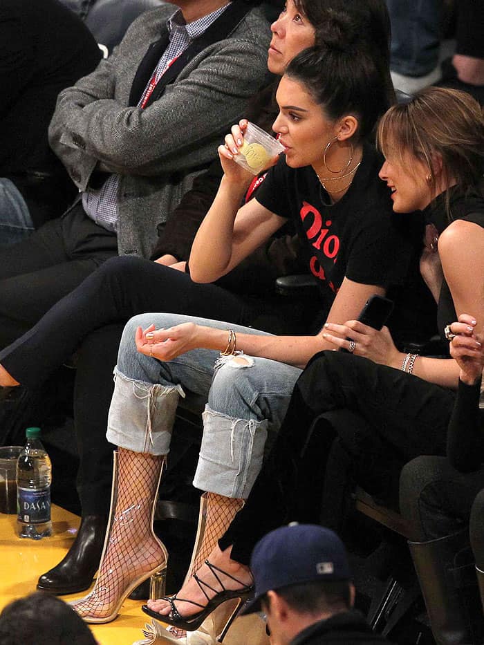 Kendall Jenner keeping sweaty feet in clear boots at bay with black fishnet stockings