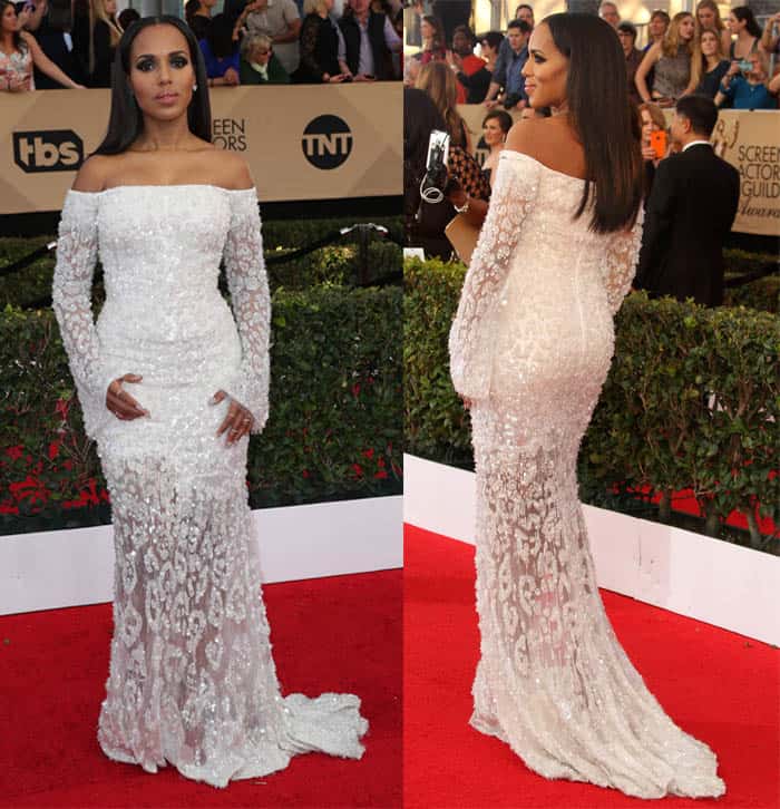 Kerry Washington stuns in an off-shoulder white gown adorned with intricate lace and beadwork, perfectly blending elegance and modern sophistication on the red carpet