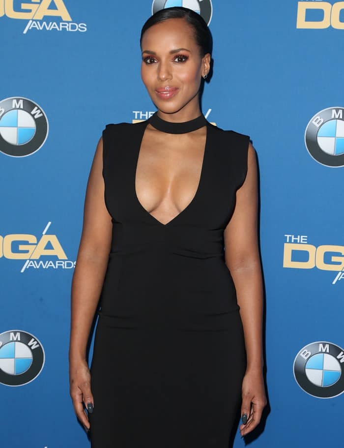 Kerry Washington wears a sleek, black, sleeveless midi dress with a plunging neckline and a trendy choker detail