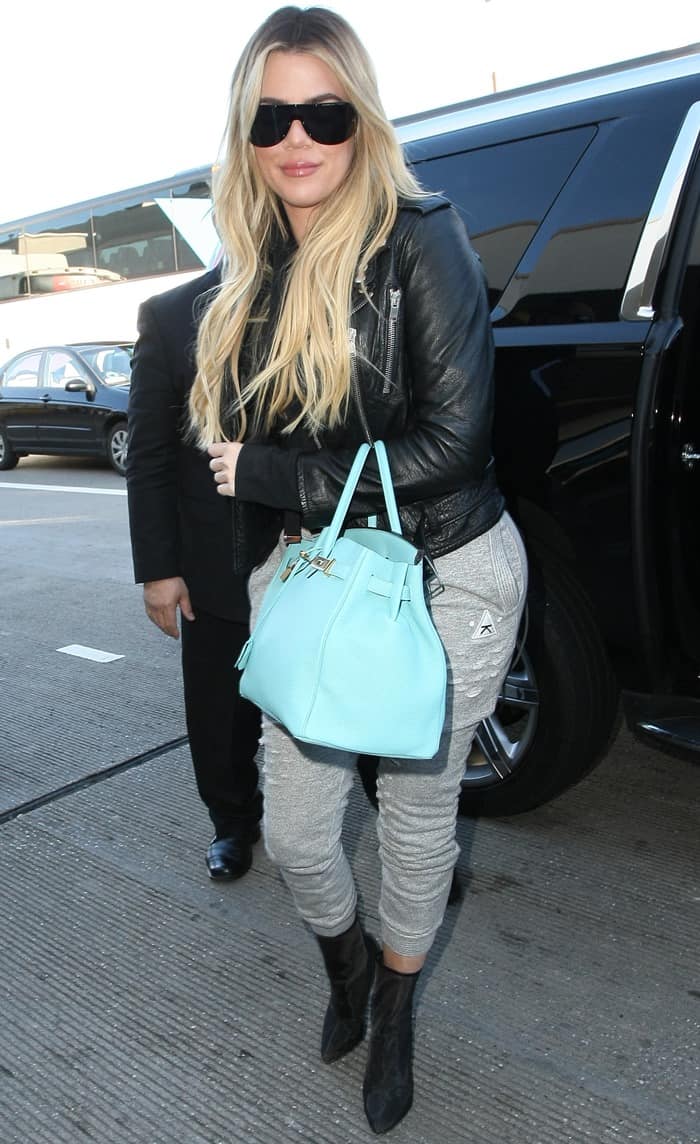 Khloé Kardashian totes a Hermès Birkin bag in Blue Atoll, a highly sought-after luxury handbag