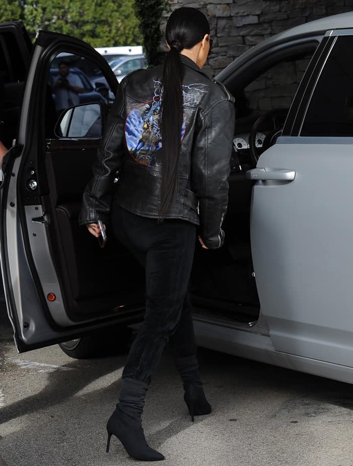 Kim Kardashian styled her motorcycle jacket with velvet jeans, a low-cut top, and ankle boots