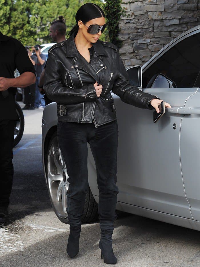 Kim Kardashian spotted wearing a black leather jacket with back to the future sunglasses while filming her reality show at Casa Vega restaurant in Sherman Oaks