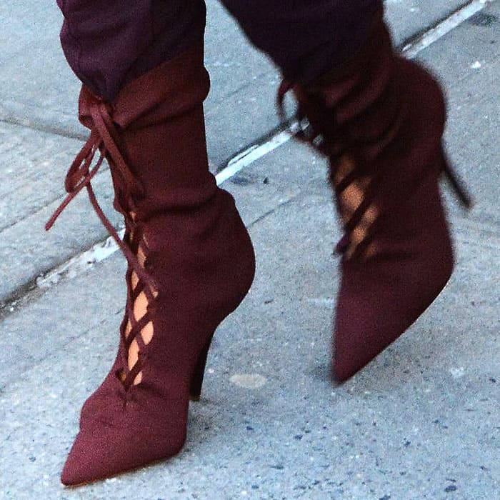 Closeup of Kim Kardashian's burgundy Yeezy lace-up boots