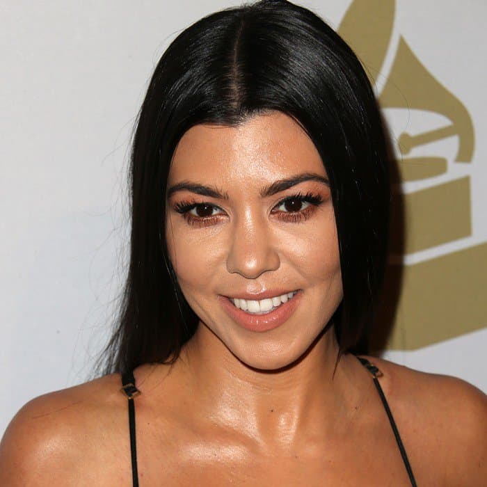 Kourtney Kardashian accentuates her brown eyes with subtle lashes and soft neutral makeup for an effortlessly radiant look