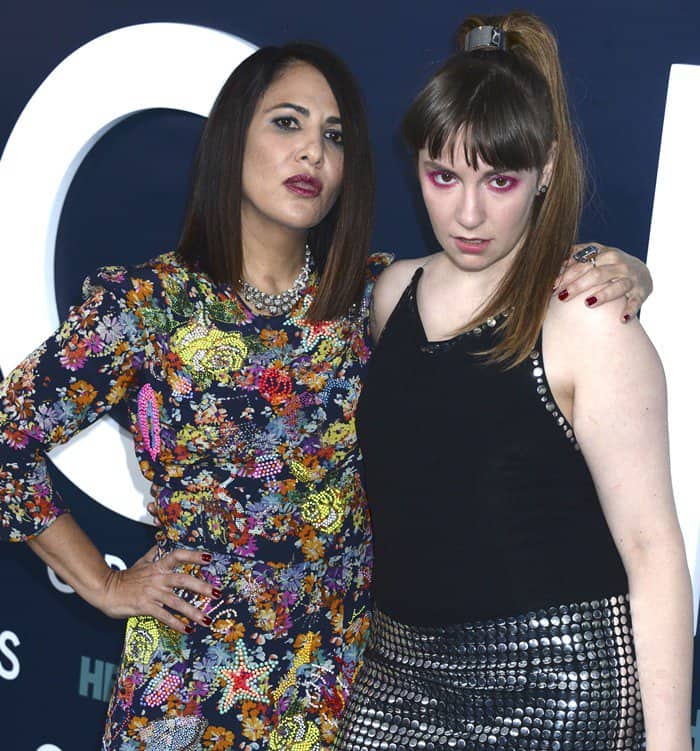 Lena Dunham, wearing a studded retro-inspired ensemble, strikes a confident pose with Jennifer Konner, the showrunner and writer of HBO's Girls