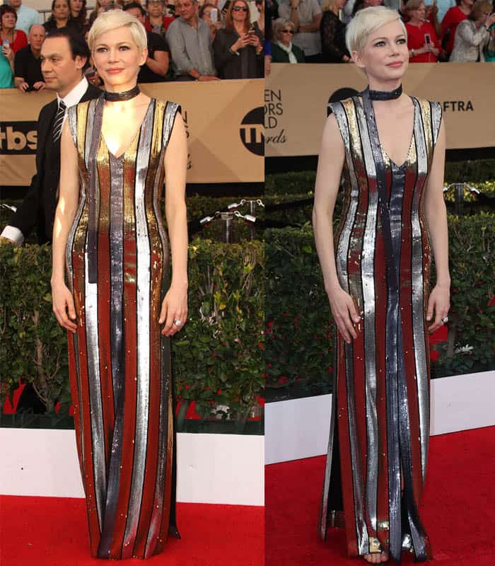 Michelle Williams stuns in a striped metallic Louis Vuitton gown with bold reflective panels, perfectly complemented by a chic choker and her signature platinum pixie cut