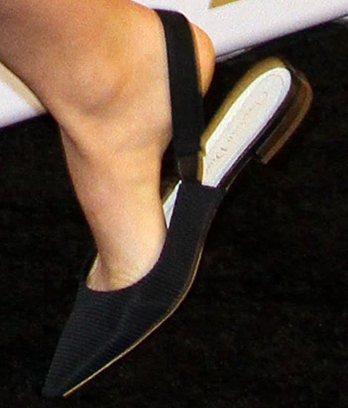 Natalie completes her look with elegant Christian Dior slingback flats, offering the perfect blend of style and comfort for moms-to-be