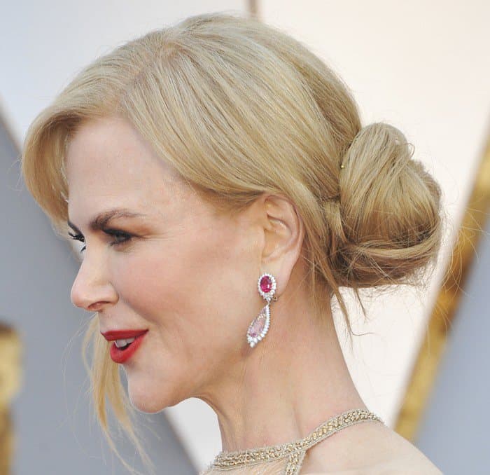 Nicole wore ruby earrings that matched her bold red lips