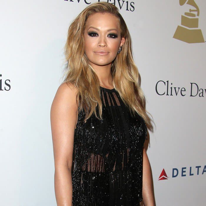 Rita Ora dazzled in a black sheer fringe dress adorned with sparkling embellishments