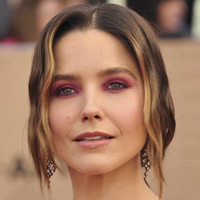 Sophia Bush stuns with vibrant fuchsia eyeshadow that perfectly complements her glowing complexion and soft waves