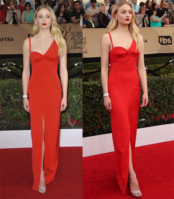 Sophie Turner turns heads in a striking red gown with a thigh-high slit and minimalist design, paired perfectly with silver heels and bold red lips for a sultry, elegant look