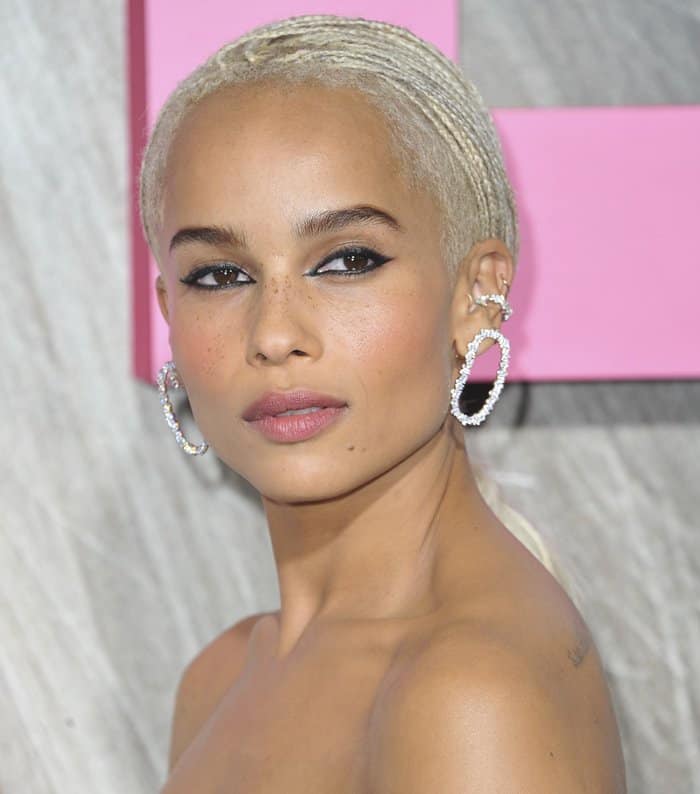 Zoë Kravitz completes her look with stunning statement earrings featuring a bold, looped design encrusted with shimmering diamonds