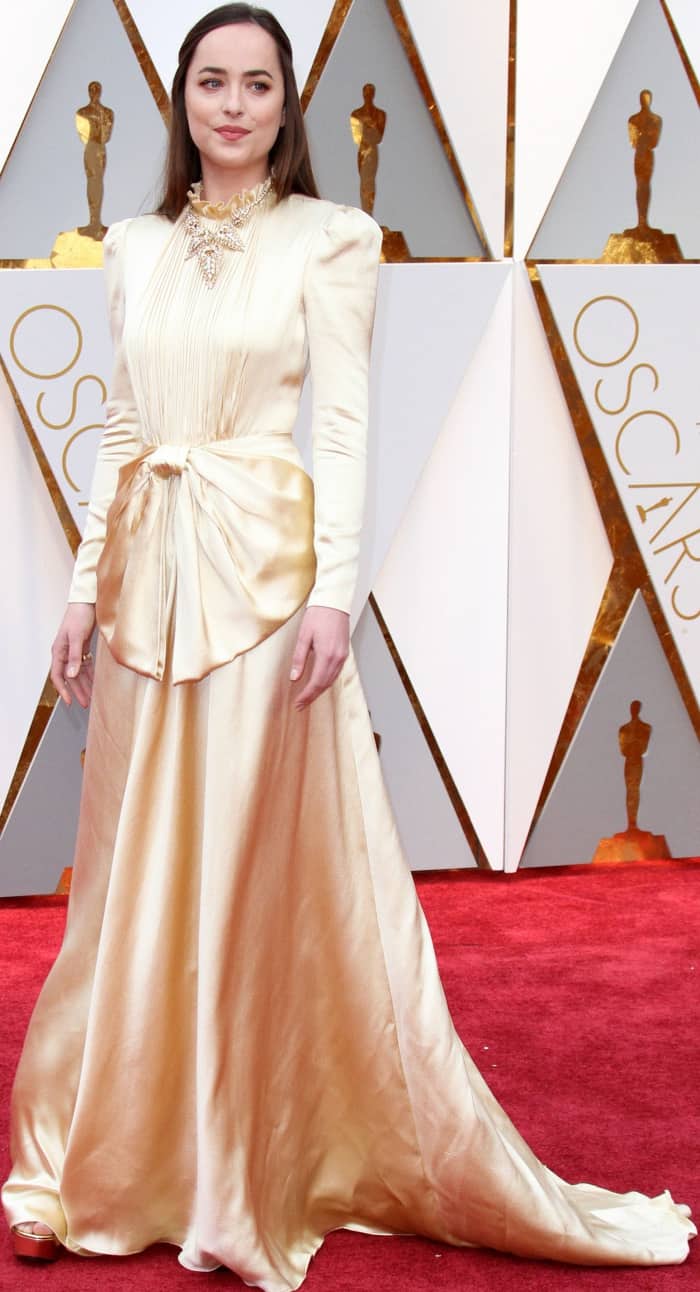 Though hidden by her flowing Gucci gown, Dakota Johnson paired her look with metallic strappy Gucci heels, adding a subtle yet elegant touch to her ensemble