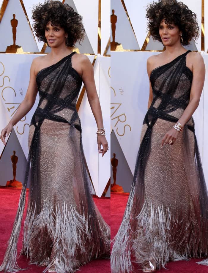 Halle Berry wearing an Atelier Versace one-shoulder gown with a metallic fringe train