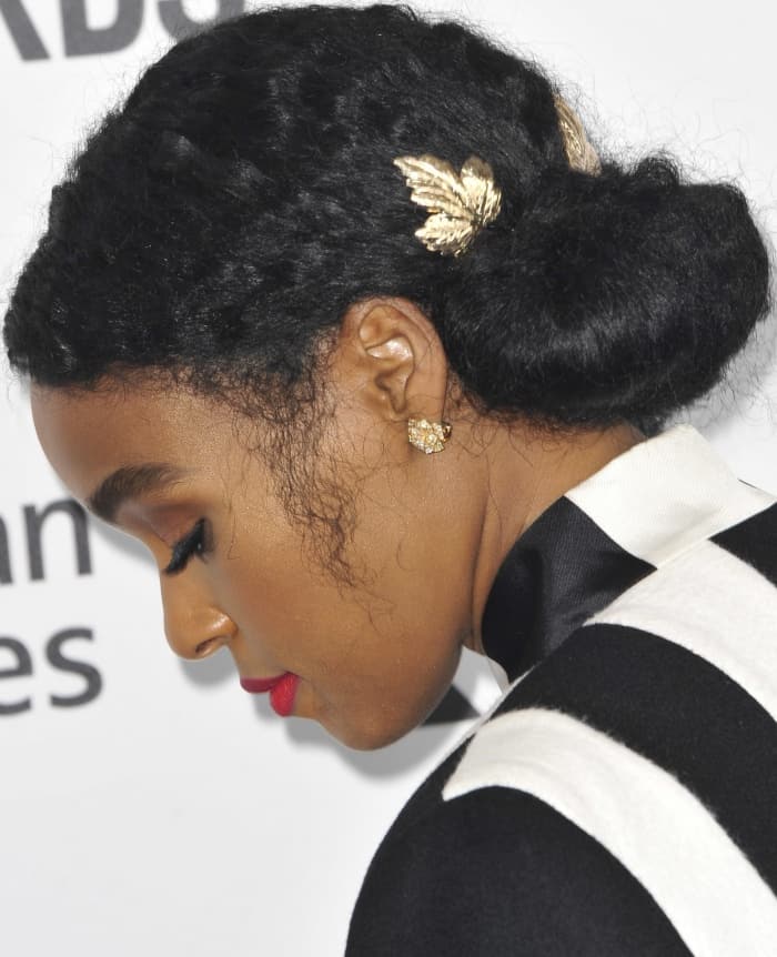 Janelle Monáe's elegant updo featured intricate braiding adorned with delicate gold leaf hair accessories