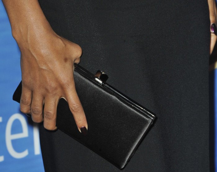 Kerry Washington completed her look with a sleek black Jimmy Choo clutch, pairing it with a chic dark manicure that added a polished and sophisticated finishing touch