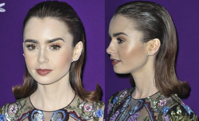 Lily Collins pairs her sleek, slicked-back hairstyle with glowing skin, bold brows, and a soft berry lip