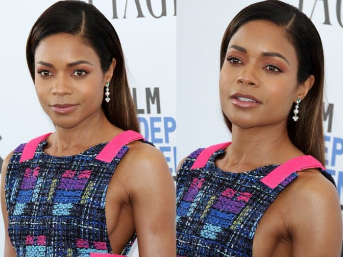 Naomie Harris complemented her look with sleek, straight hair tucked elegantly behind her ears, showcasing her delicate dangling earrings that added just the right amount of sparkle to her refined ensemble