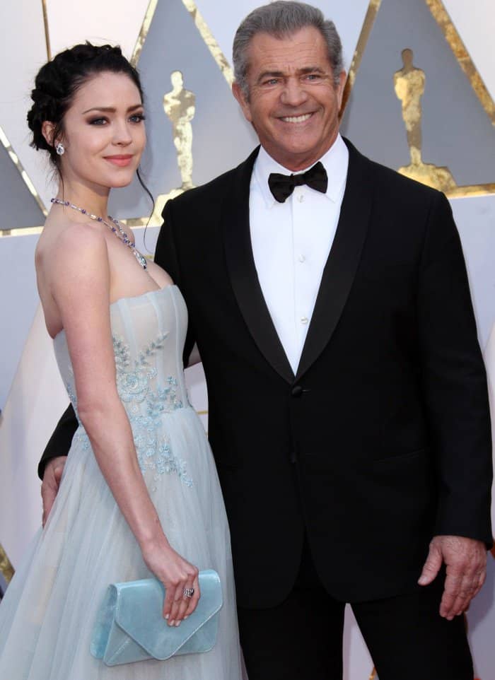 Rosalind Ross wearing a powder blue gown and Mel Gibson wearing a Giorgio Armani suit at the 2017 Oscars
