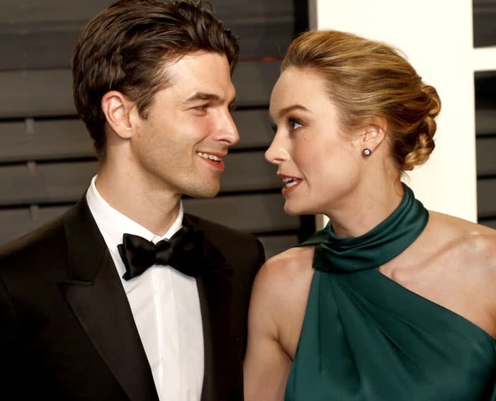 Brie Larson shares a sweet moment with her fiancé, Alex Greenwald, at the 2017 Vanity Fair Oscar Party, both dressed to impress for the glamorous evening