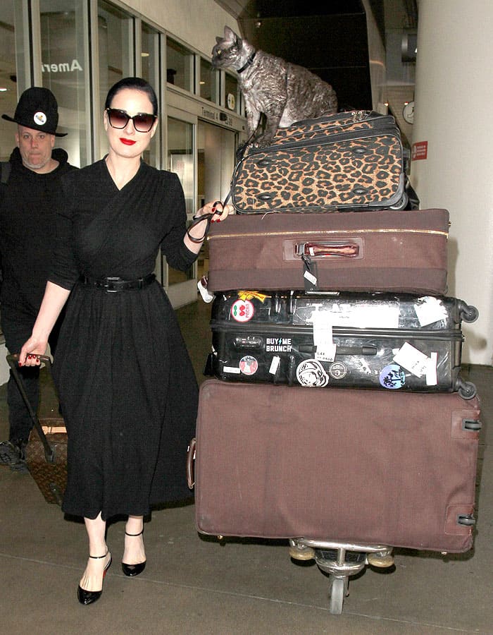 Dita Von Teese traveling with her Devonshire Rex cat named Aleister