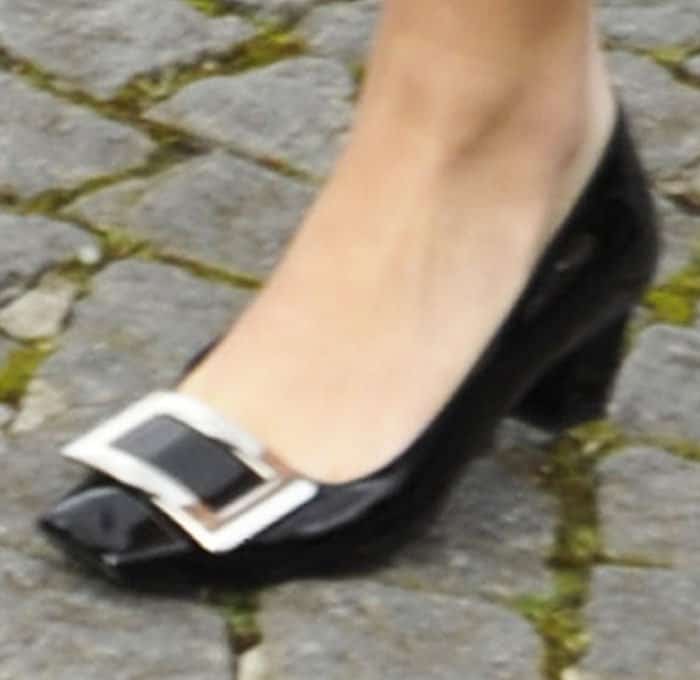 Emily wears a pair of Miu Miu's iconic buckled pumps