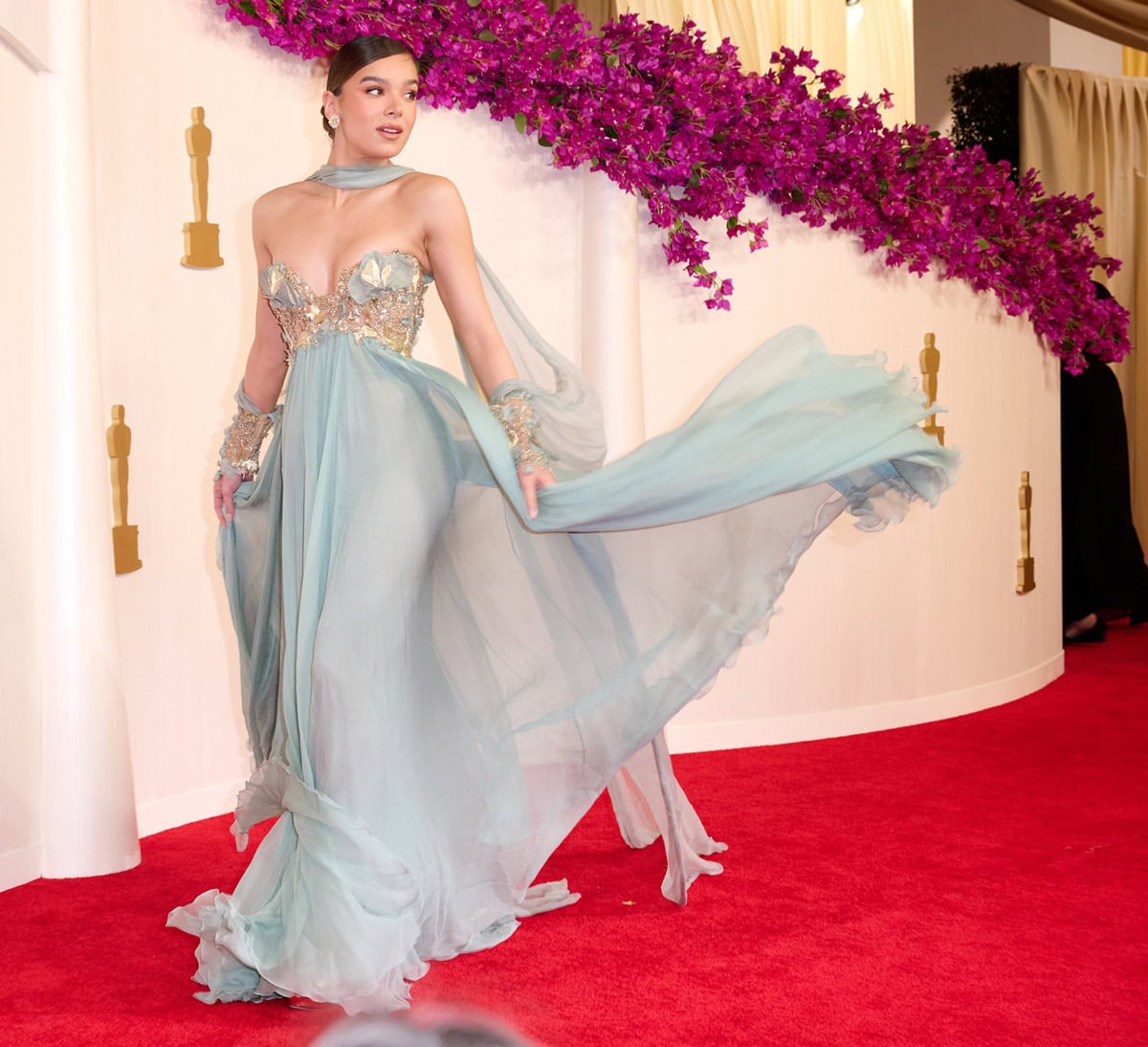 Hailee Steinfeld brought fairytale glamour to the 2024 Oscars in a pastel blue Elie Saab Haute Couture gown paired with Jimmy Choo Max sandals and Chopard jewels