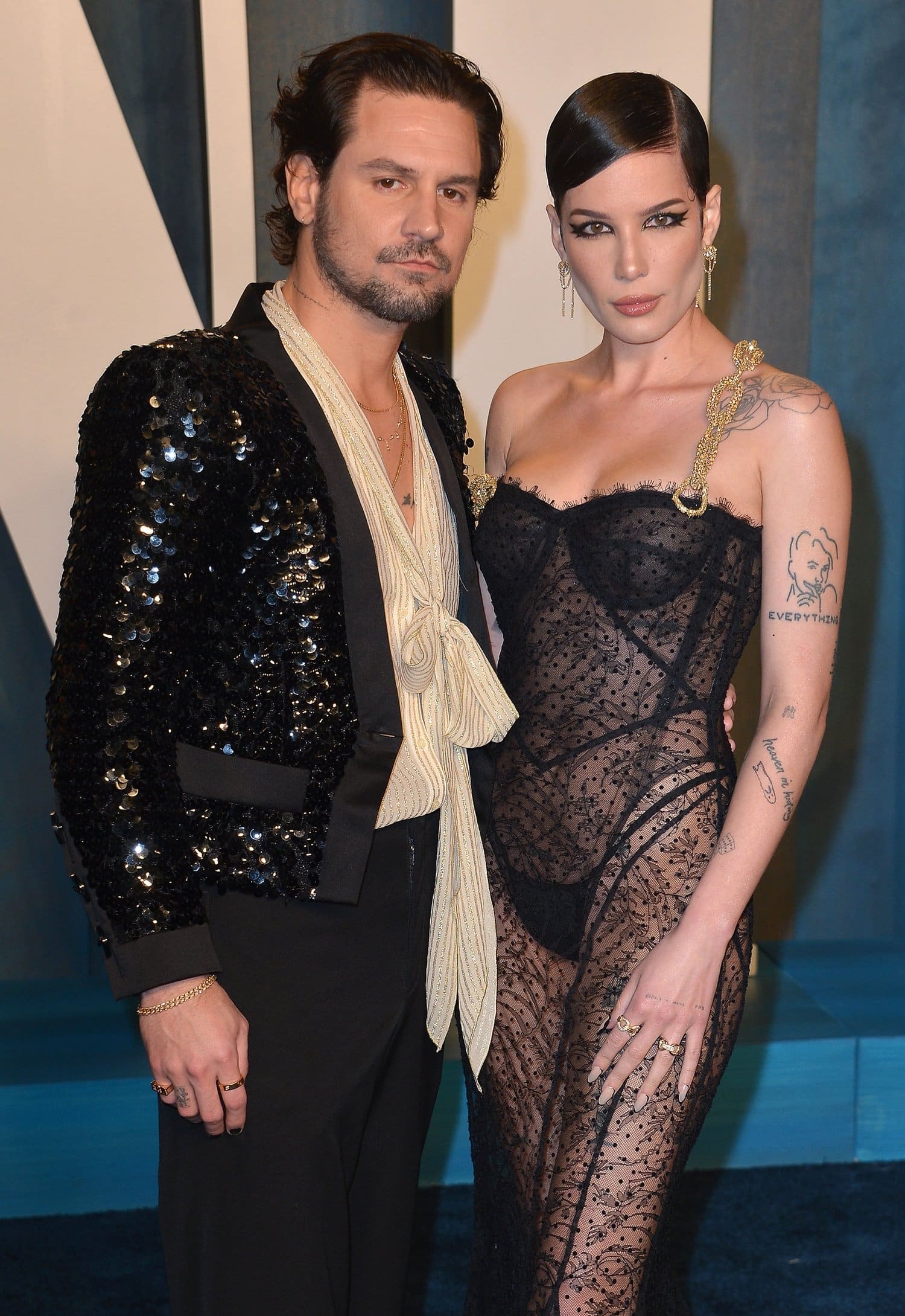 Halsey, in a sheer Dolce & Gabanna dress that displayed her underwear, and her boyfriend Alev Aydin attend the 2022 Vanity Fair Oscar Party