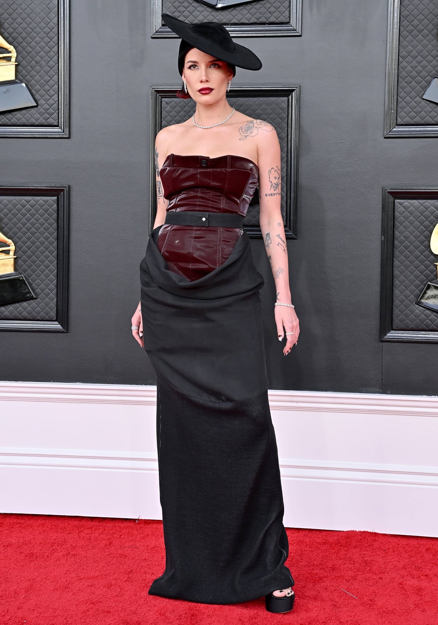 Halsey in a black Pressiat Fall 2022 dress with a vintage Pierre Cardin hat at the 64th Annual GRAMMY Awards