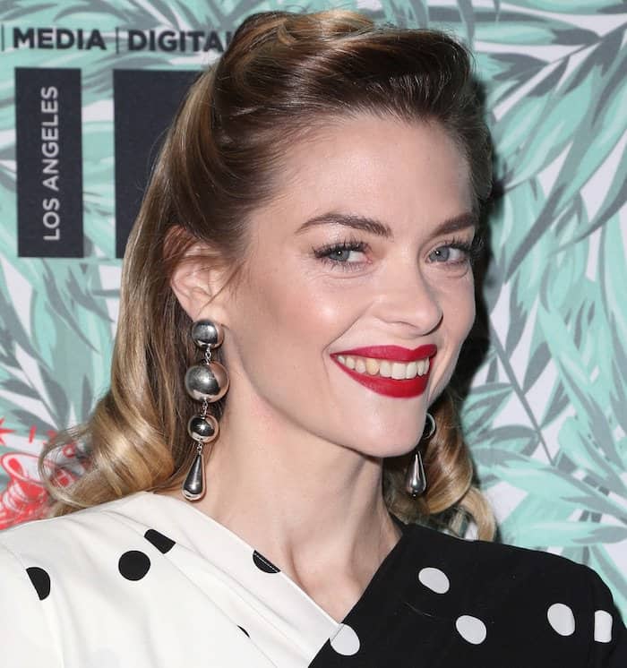She went for bold red lips, a glamorous updo, and accessorized with gold chandelier earrings