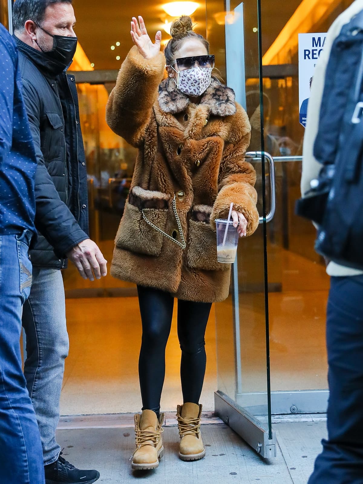 Jennifer Lopez wears a Coach x Schott NYC shearling coat with leggings and Timberland x Jimmy Choo boots