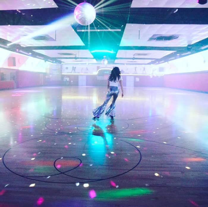 Jessica Biel enjoys a dreamy roller-skating night under a dazzling disco ball, embracing retro vibes in flared pants and effortless style